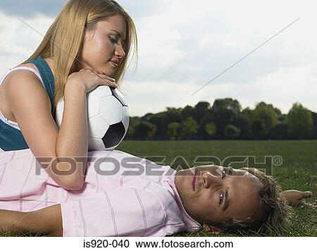 Young couple lying in a park View Large Photo Image Stock Image - Young couple lying in a park. Fotosearch