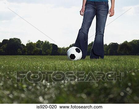 Stock Image - Young woman with a football. Fotosearch