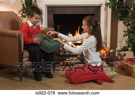 Stock Photo - Children opening christmas presents. Fotosearch