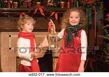 Stock Photo - Children singing christmas carols. Fotosearch