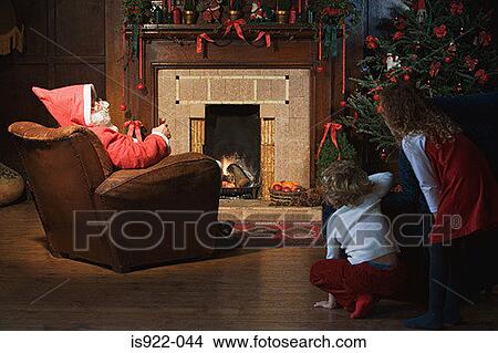 Children watching santa claus in living room View Large Photo Image Picture - Children watching santa claus in living room. Fotosearch