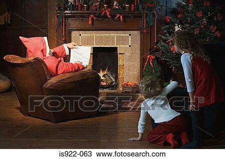 Children watching santa claus in living room View Large Photo Image Stock Image - Children watching santa claus in living room. Fotosearch
