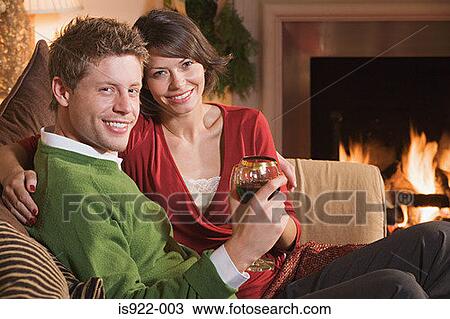 Couple resting by fireplace View Large Photo Image Stock Image - Couple resting by fireplace. Fotosearch