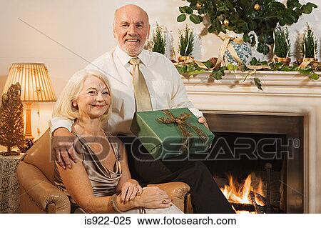 Stock Photography - Elderly couple exchanging gifts. Fotosearch