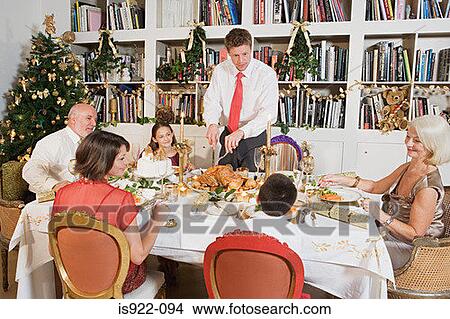 Family at dining table at christmas View Large Photo Image Picture - Family at dining table at christmas. Fotosearch