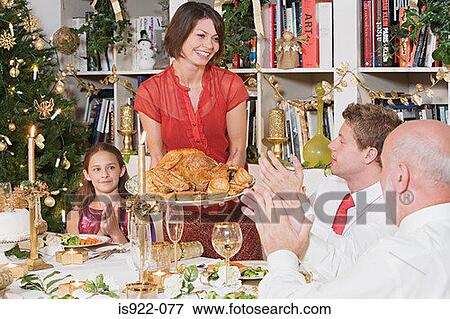 Family at dining table at christmas View Large Photo Image Stock Photo - Family at dining table at christmas. Fotosearch