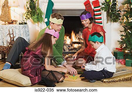Family playing a board game at christmas View Large Photo Image Stock Photography - Family playing a board game at christmas. Fotosearch