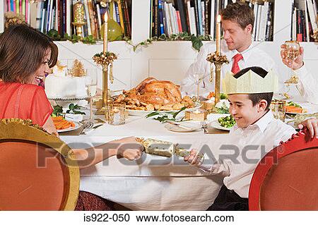 Family pulling christmas crackers View Large Photo Image Stock Image - Family pulling christmas crackers. Fotosearch