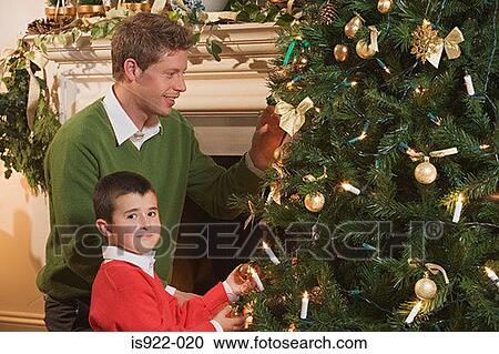 Father and son decorating a christmas tree View Large Photo Image Stock Image - Father and son decorating a christmas tree. Fotosearch