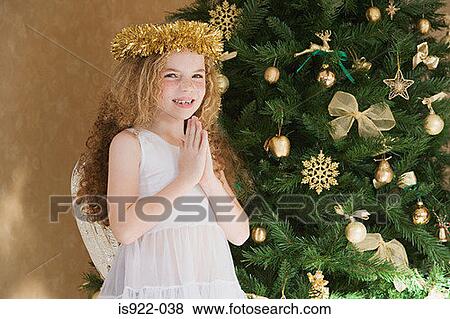 Stock Photo - Girl dressed as an angel at christmas. Fotosearch