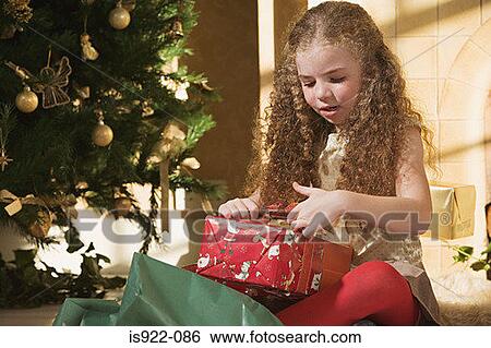 Girl opening christmas presents View Large Photo Image Stock Photograph - Girl opening christmas presents. Fotosearch