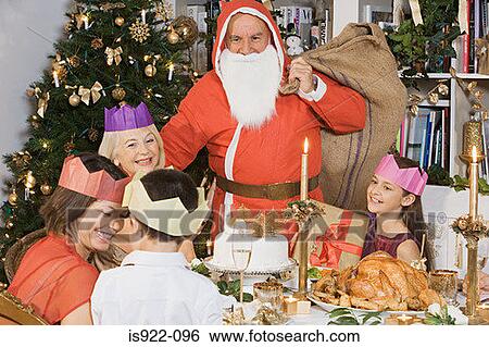 Stock Photograph - Santa claus at christmas dinner. Fotosearch