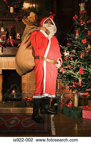 Santa claus delivering gifts View Large Photo Image Stock Image - Santa claus delivering gifts. Fotosearch