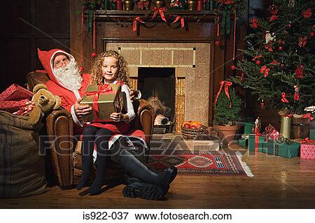 Santa claus giving girl a gift View Large Photo Image Stock Photo - Santa claus giving girl a gift. Fotosearch