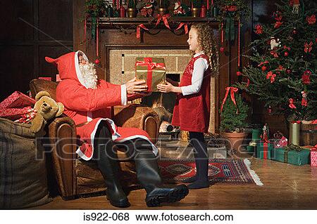 Stock Photo - Santa claus giving girl a gift. Fotosearch