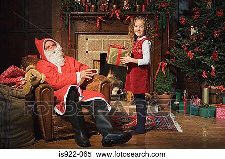 Santa claus giving girl a gift View Large Photo Image Stock Photography - Santa claus giving girl a gift. Fotosearch