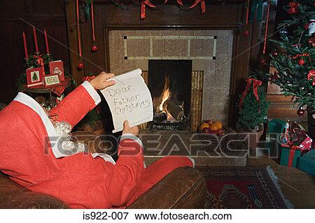 Santa claus reading a letter View Large Photo Image Stock Photo - Santa claus reading a letter. Fotosearch