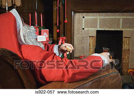 Santa claus resting by the fireplace View Large Photo Image Stock Photo - Santa claus resting by the fireplace. Fotosearch