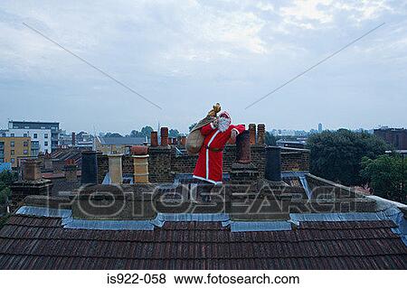 Santa claus standing on a roof View Large Photo Image Stock Photo - Santa claus standing on a roof. Fotosearch