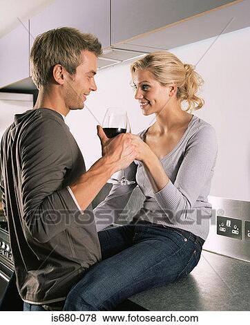 Couple having a glass of wine View Large Photo Image Stock Photo - Couple having a glass of wine. Fotosearch