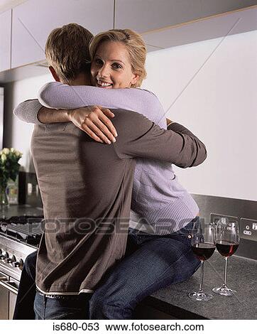 Couple hugging in the kitchen View Large Photo Image Stock Image - Couple hugging in the kitchen. Fotosearch