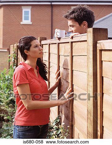 Man and woman talking over garden fence View Large Photo Image Stock Photo - Man and woman talking over garden fence. Fotosearch