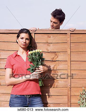 Man looking at woman over garden fence View Large Photo Image Stock Image - Man looking at woman over garden fence. Fotosearch