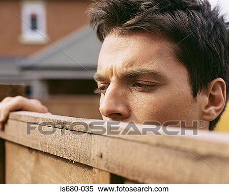 Man looking over garden fence View Large Photo Image Stock Photography - Man looking over garden fence. Fotosearch