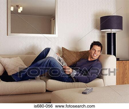 Stock Photograph - Man relaxing on sofa. Fotosearch