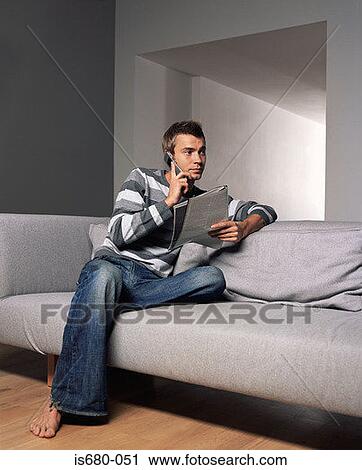 Man with magazine and mobile phone View Large Photo Image Stock Image - Man with magazine and mobile phone. Fotosearch