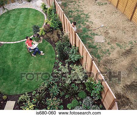 Neighbours talking over garden the fence View Large Photo Image Stock Image - Neighbours talking over garden the fence. Fotosearch
