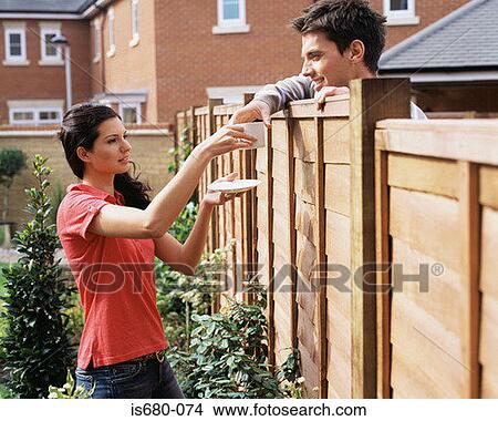 Woman giving coffee to neighbour View Large Photo Image Picture - Woman giving coffee to neighbour. Fotosearch