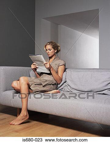 Stock Image - Woman reading a magazine. Fotosearch