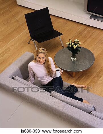 Woman relaxing with a cup of coffee View Large Photo Image Stock Image - Woman relaxing with a cup of coffee. Fotosearch
