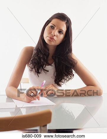Young woman writing a letter View Large Photo Image Stock Photo - Young woman writing a letter. Fotosearch