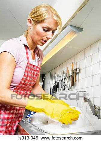 Stock Photograph - Housewife doing washing up. Fotosearch