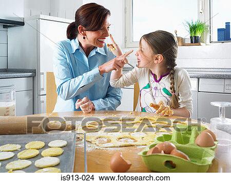 Picture - Mother and daughter having fun baking. Fotosearch
