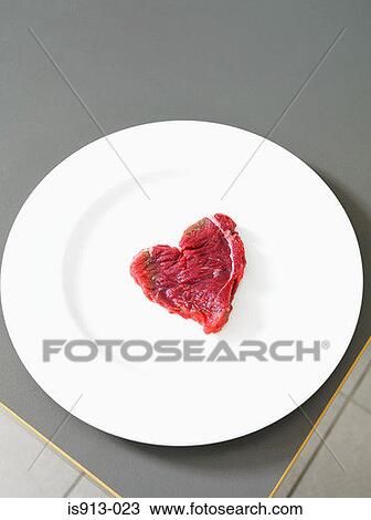 Stock Image - Steak in the shape of a heart. Fotosearch