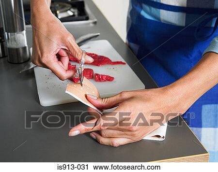 Woman cutting adhesive plaster to put on her finger View Large Photo Image Stock Image - Woman cutting adhesive plaster to put on her finger. Fotosearch
