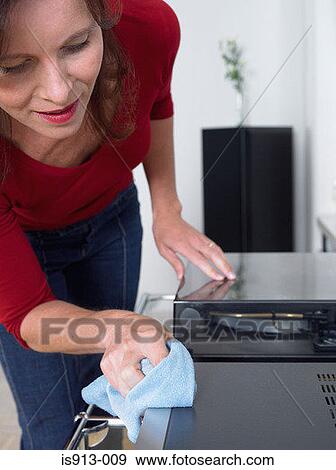 Woman dusting stereo View Large Photo Image Stock Photo - Woman dusting stereo. Fotosearch