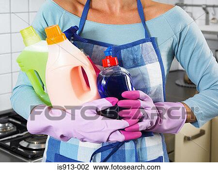 Woman holding cleaning products View Large Photo Image Stock Image - Woman holding cleaning products. Fotosearch