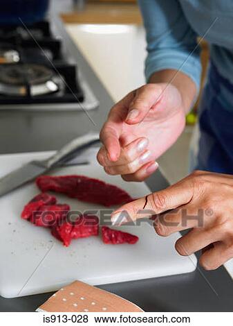 Woman in kitchen with cut on her finger View Large Photo Image Stock Photo - Woman in kitchen with cut on her finger. Fotosearch