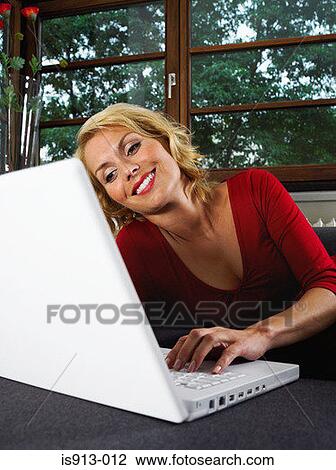 Woman using laptop computer View Large Photo Image Stock Image - Woman using laptop computer. Fotosearch