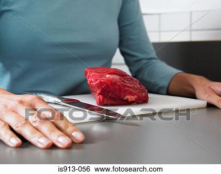Woman with beef on chopping board View Large Photo Image Stock Photograph - Woman with beef on chopping board. Fotosearch