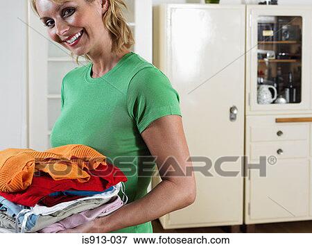 Woman with pile of laundry View Large Photo Image Stock Photo - Woman with pile of laundry. Fotosearch