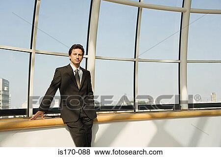 Businessman by a window View Large Photo Image Stock Photo - Businessman by a window. Fotosearch