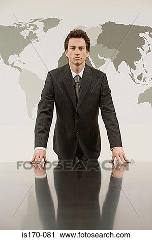 Businessman in front a map of the world View Large Photo Image Stock Image - Businessman in front a map of the world . Fotosearch