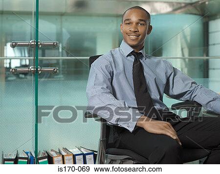 Businessman in his office View Large Photo Image Stock Photo - Businessman in his office. Fotosearch