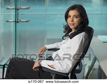 Stock Photo - Businesswoman sitting in a chair. Fotosearch