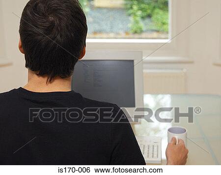 Man at his computer View Large Photo Image Stock Photograph - Man at his computer. Fotosearch